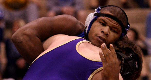 Lake Central's Gelen Robinson hangs onto Hobart's Jon Ramirez during Saturday's semifinals of the Lake County Championships.